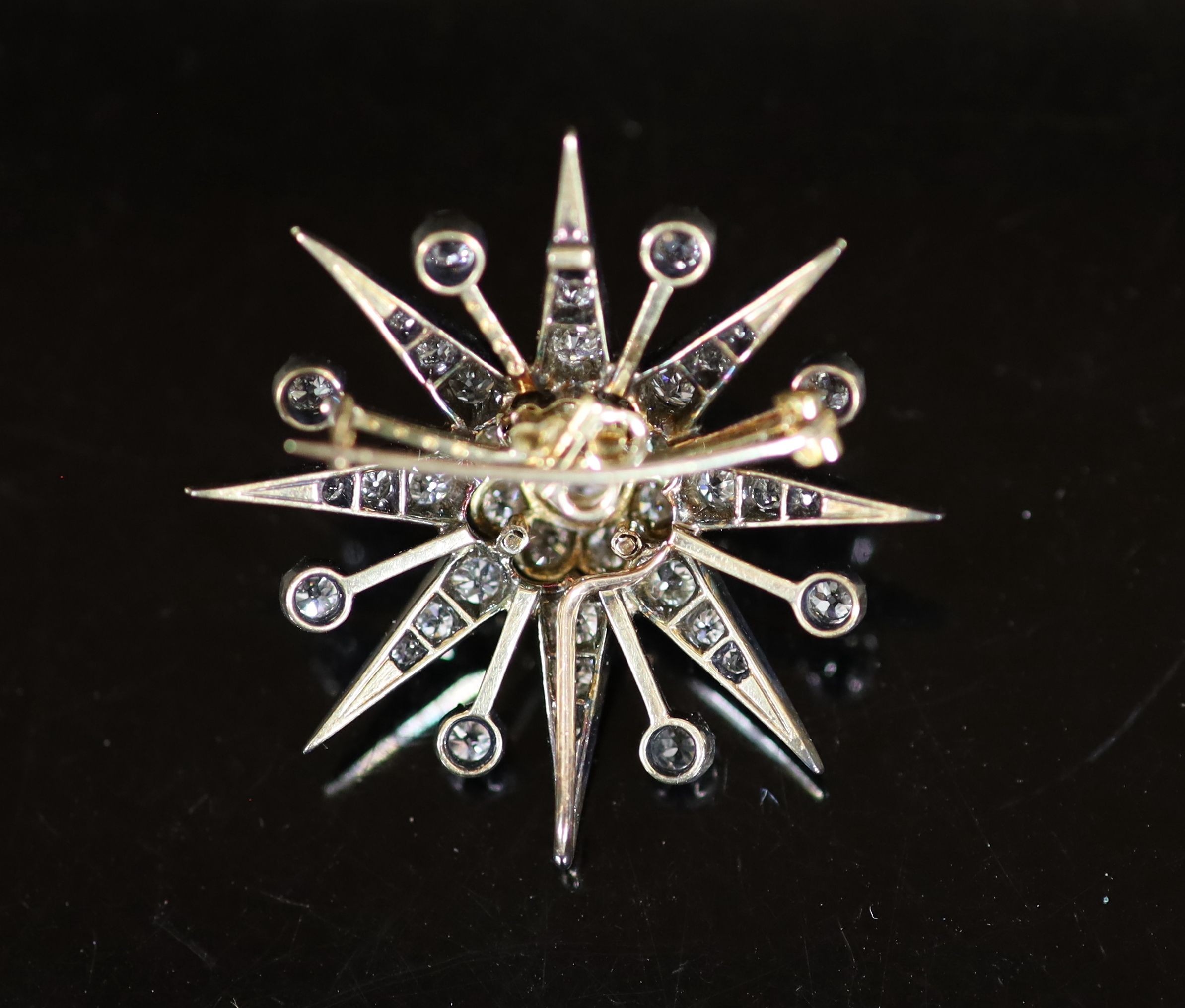 A Victorian gold, silver and diamond set starburst pendant brooch